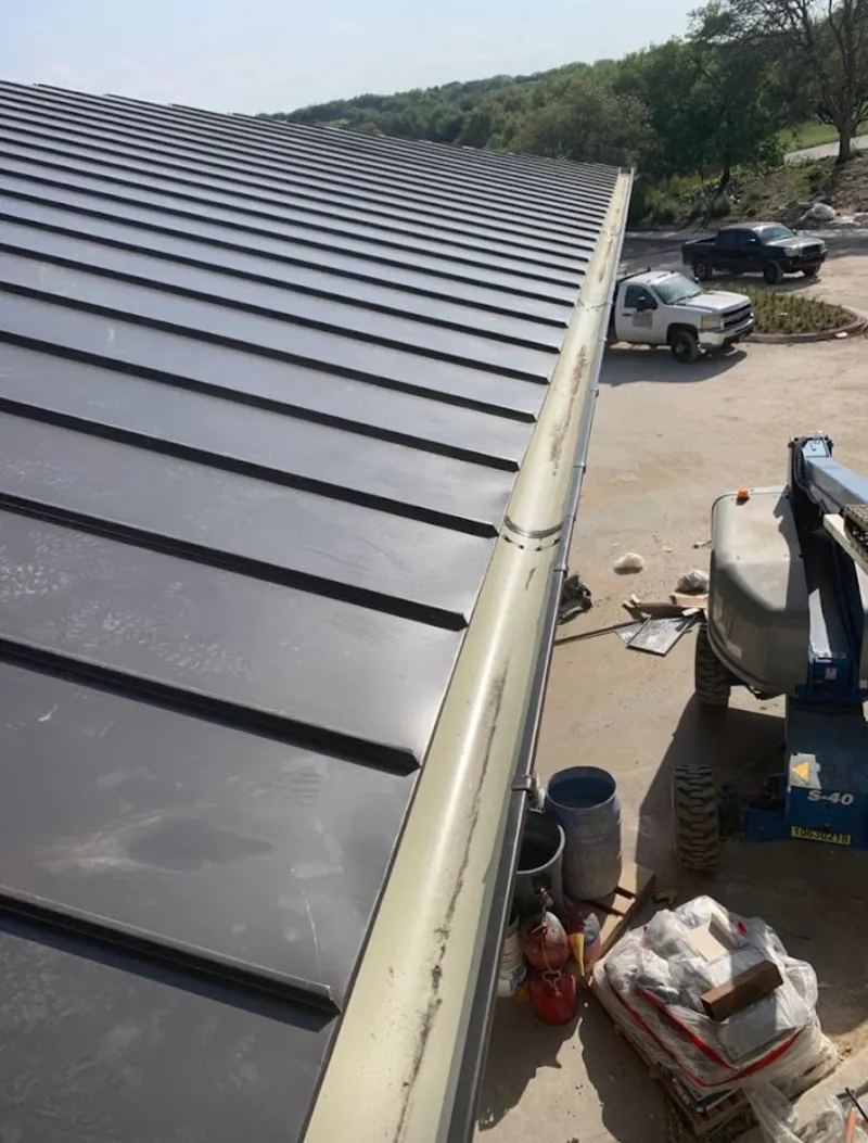 Standing seam panel and gutter detail on a metal roofing jobsite in Santa Fe